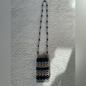 Beautiful Handmade Beaded Phone Bag with elastic clasp on front to ensure closed